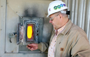 Director of the Gibbons Creek Steam Electric Station, Craig York, on the 17th story of the power plant opens a door to show the glowing, 2,000 degree fireball inside the coal-fired boiler. The fireball is controlled by adjusting air-to-fuel mixtures, chemical conditions, oxidation of mercury and formation of carbon monoxide.
